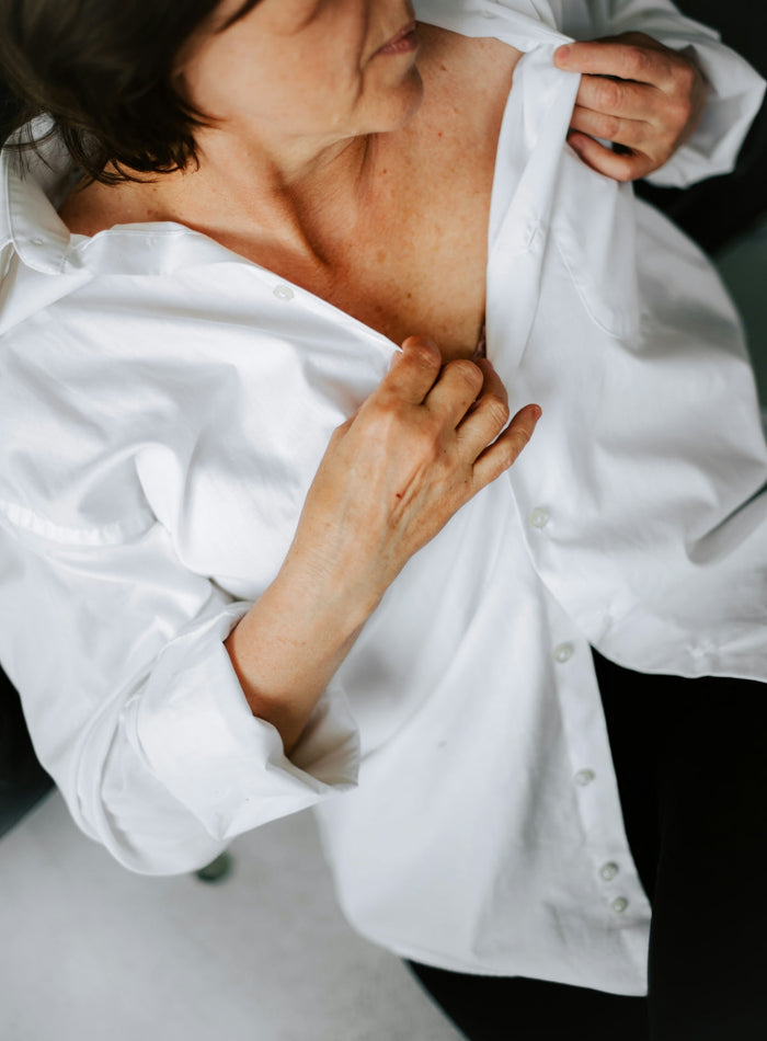a woman in a white shirt and black pants