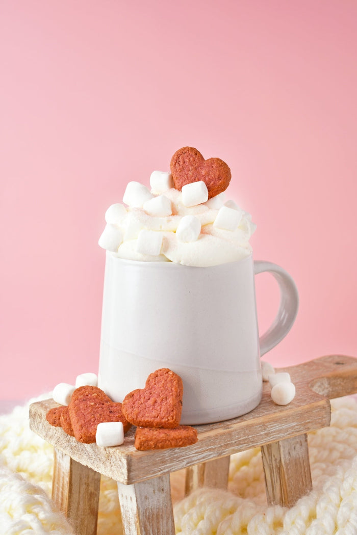 A cup of hot chocolate with marshmallows on a wooden sled