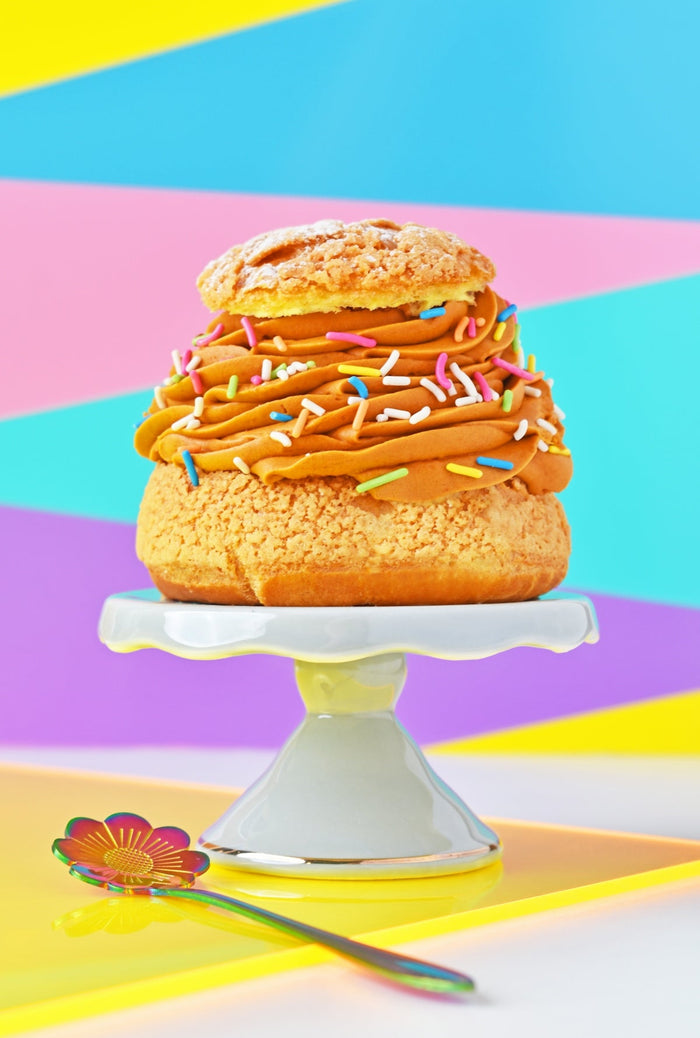 A cake on a cake stand with a fork