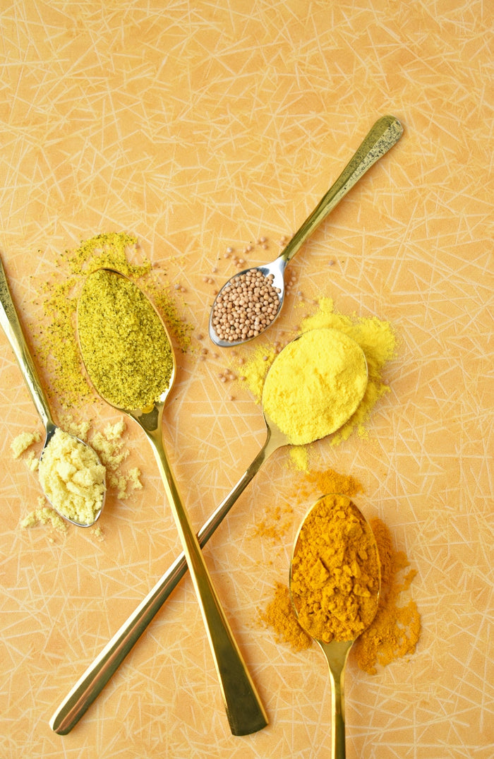 A group of spoons filled with different types of food